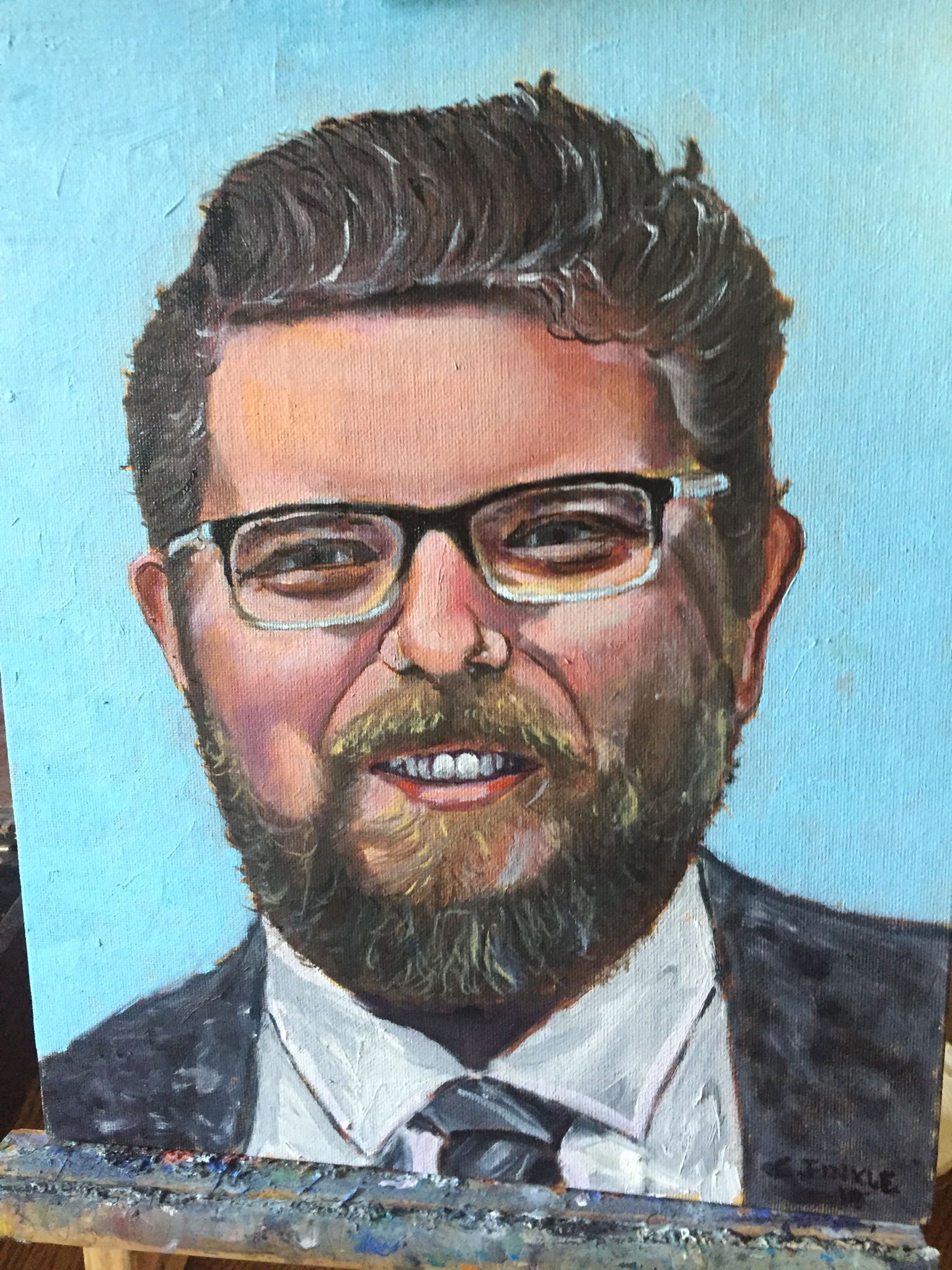 Portrait painting of Andrew with glasses, a beard and a suit.