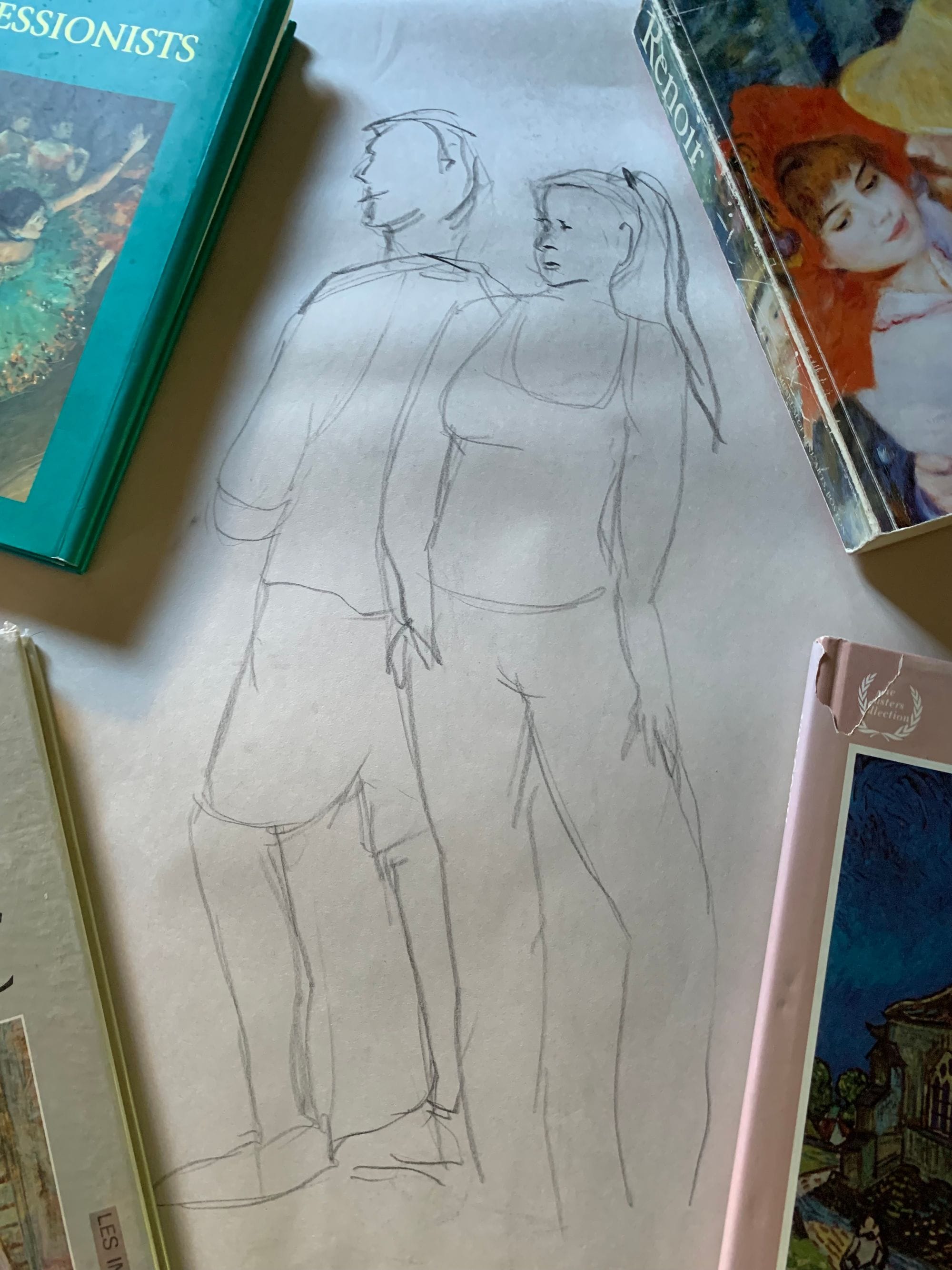 Line drawing of two standing figures on a sheet of paper.