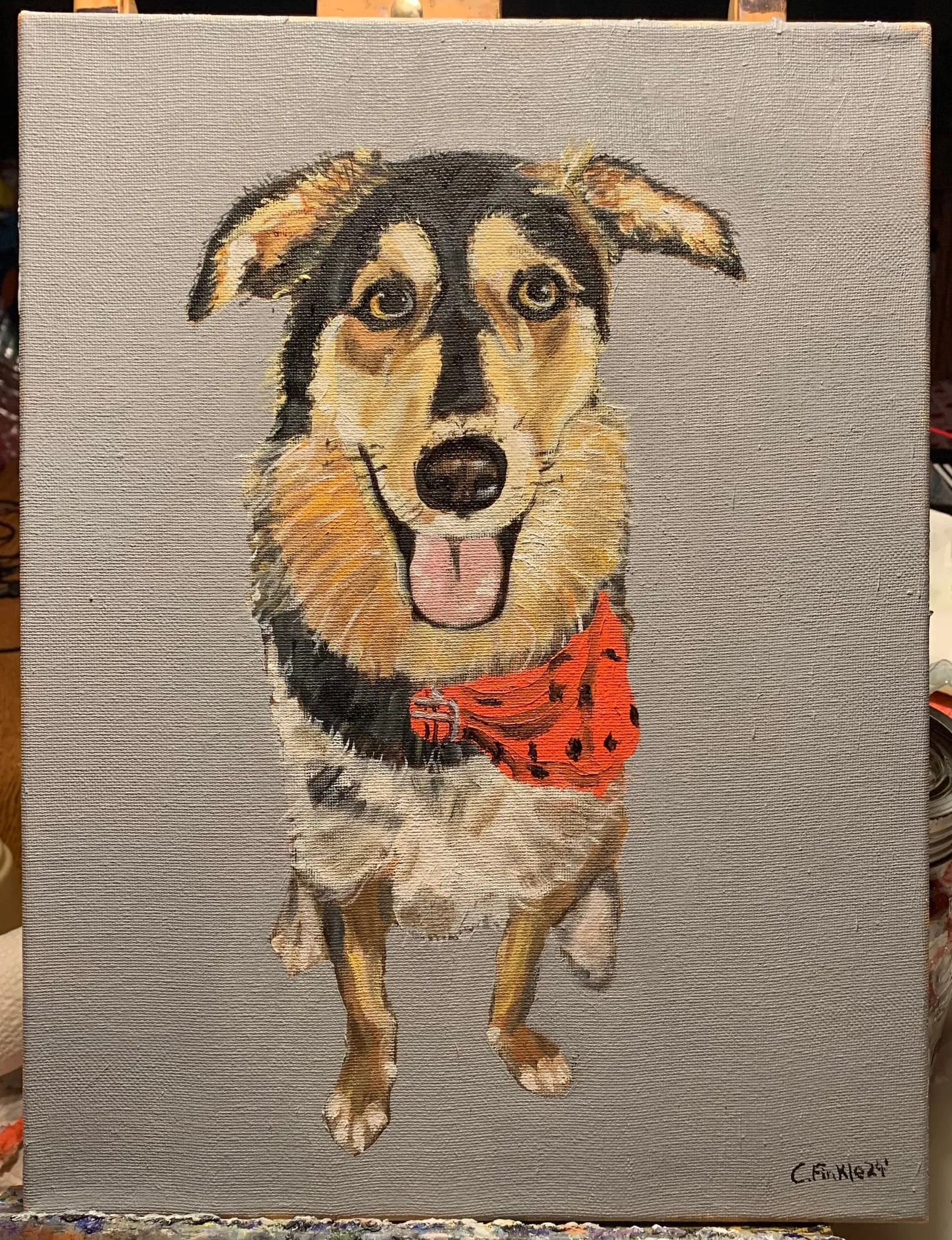 Portrait painting of a black-and-tan dog with a red bandana.