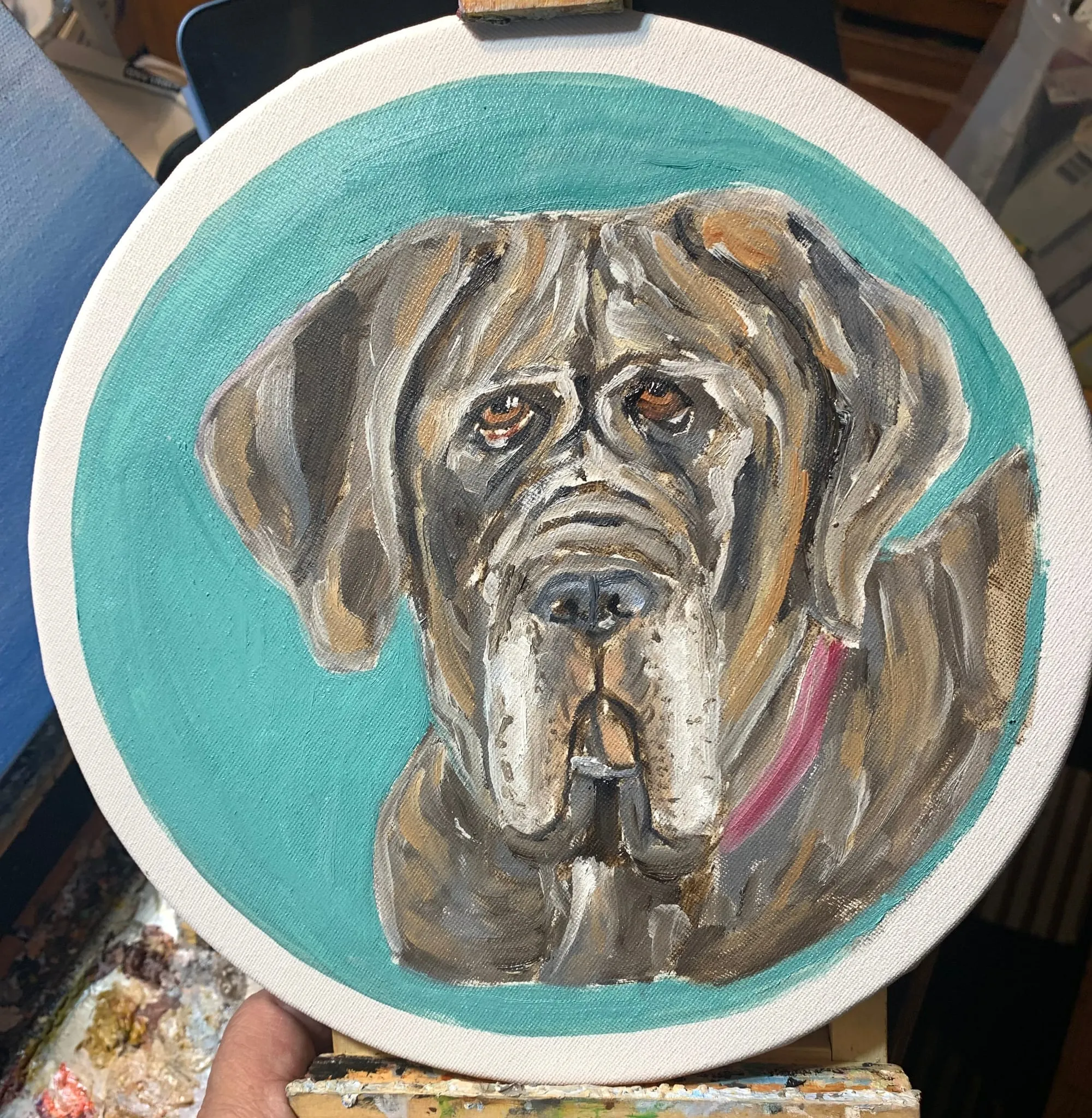 Portrait painting of a large brown dog on a circular surface with a turquoise background.