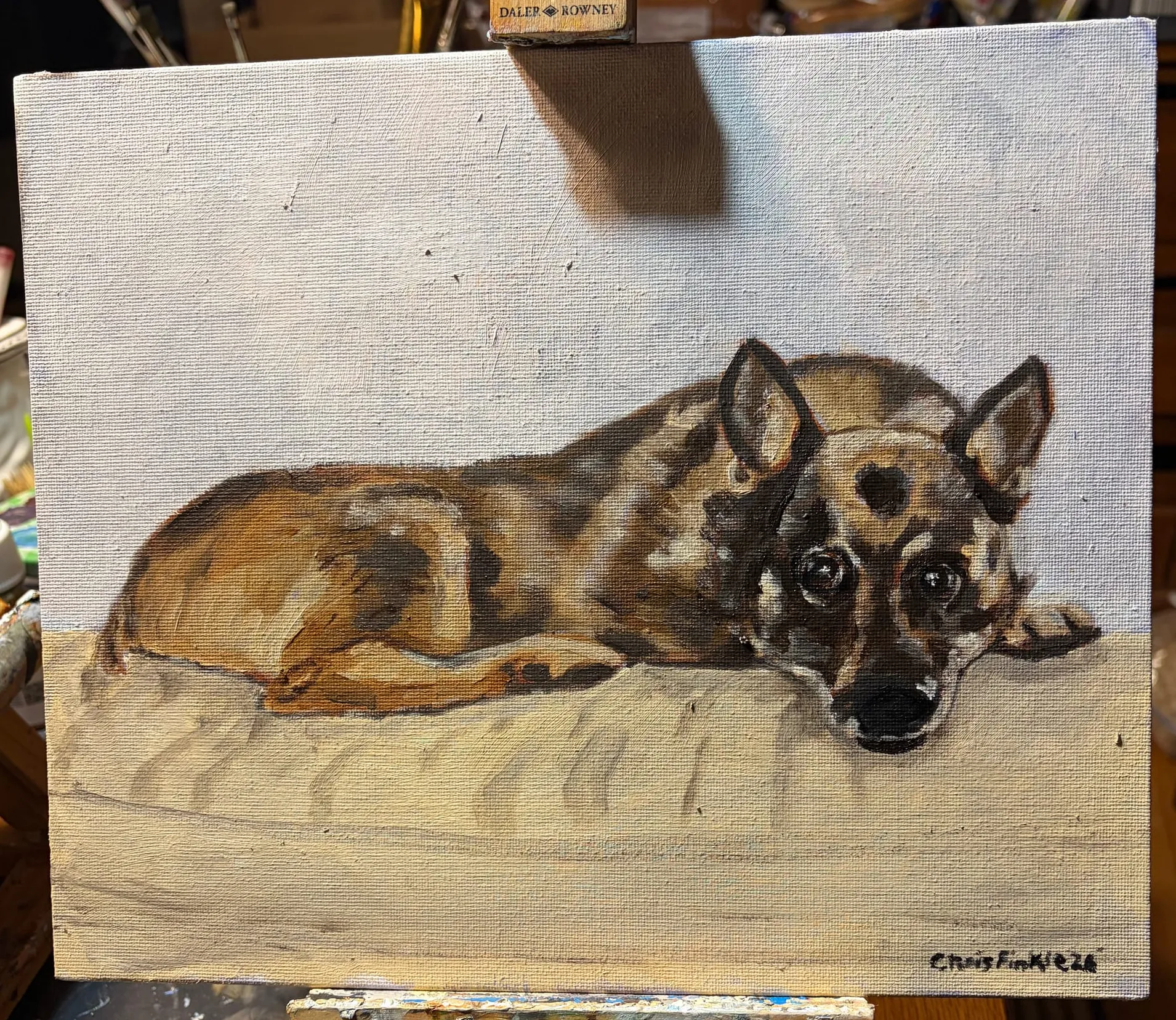 Painting of a brown-and-black dog resting its head on a pale cushion.