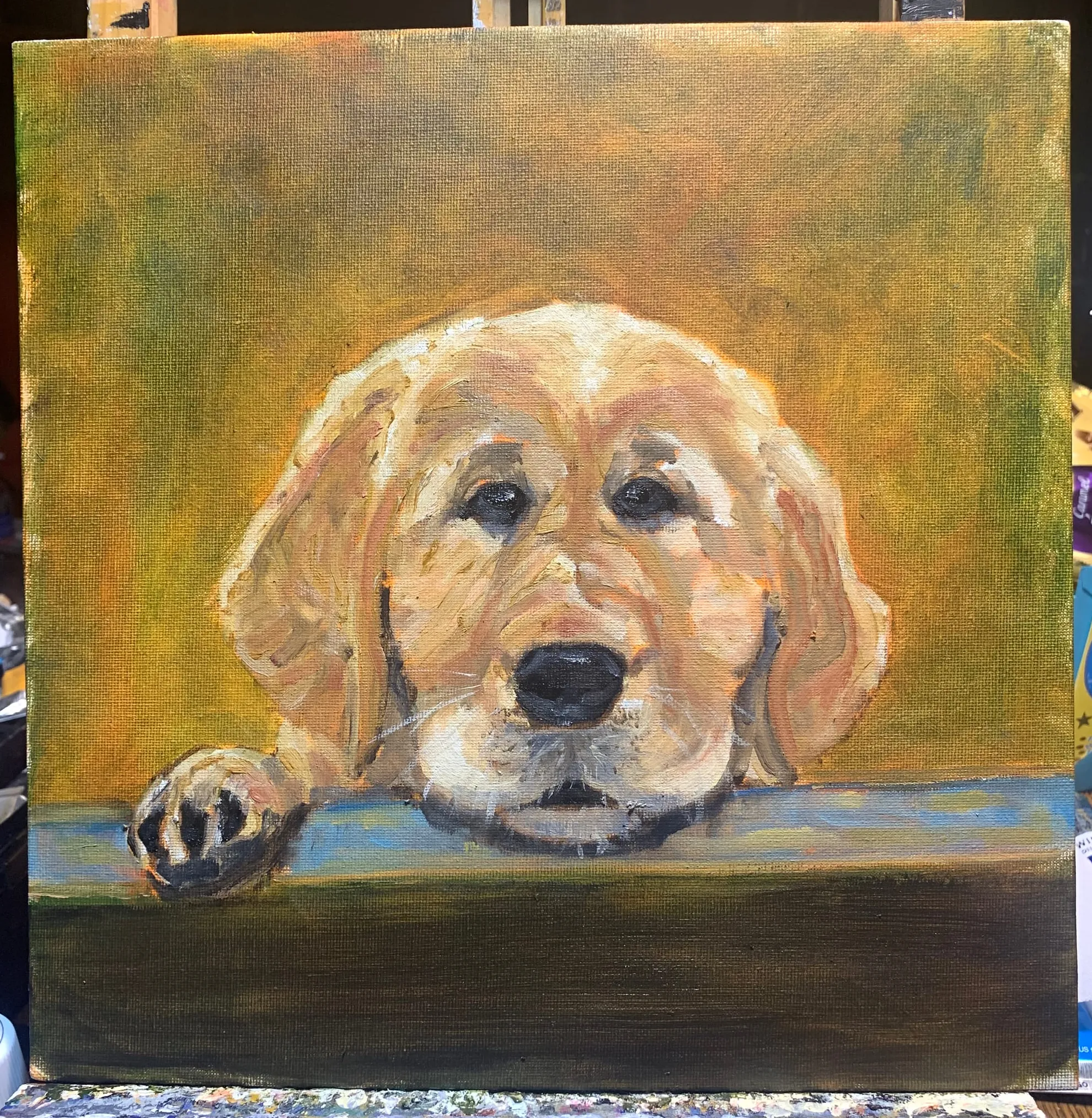 Painting of a golden-coloured puppy looking over a dark ledge.