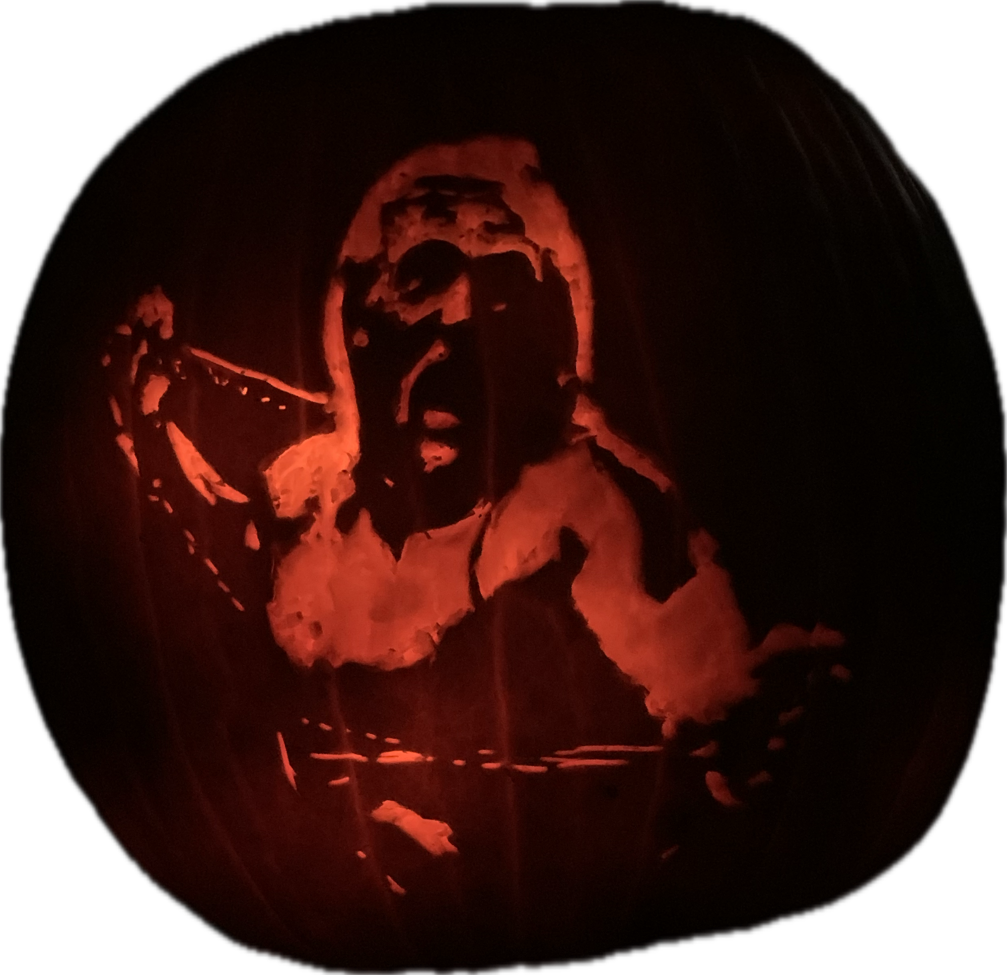 Illuminated pumpkin carving depicting a long-haired wrestler with an open mouth.