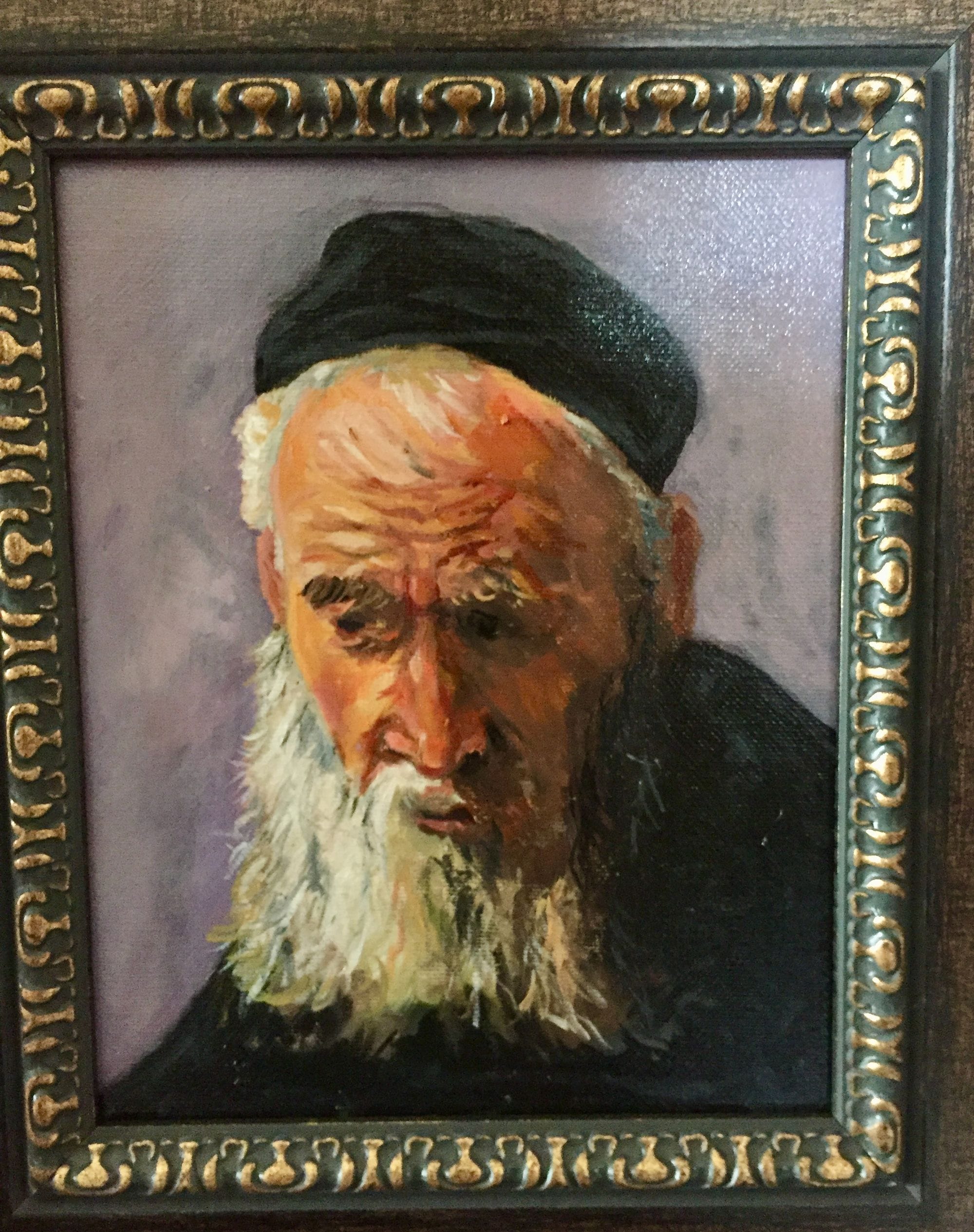 Framed portrait study of an older white-bearded man looking down beneath a black cap.