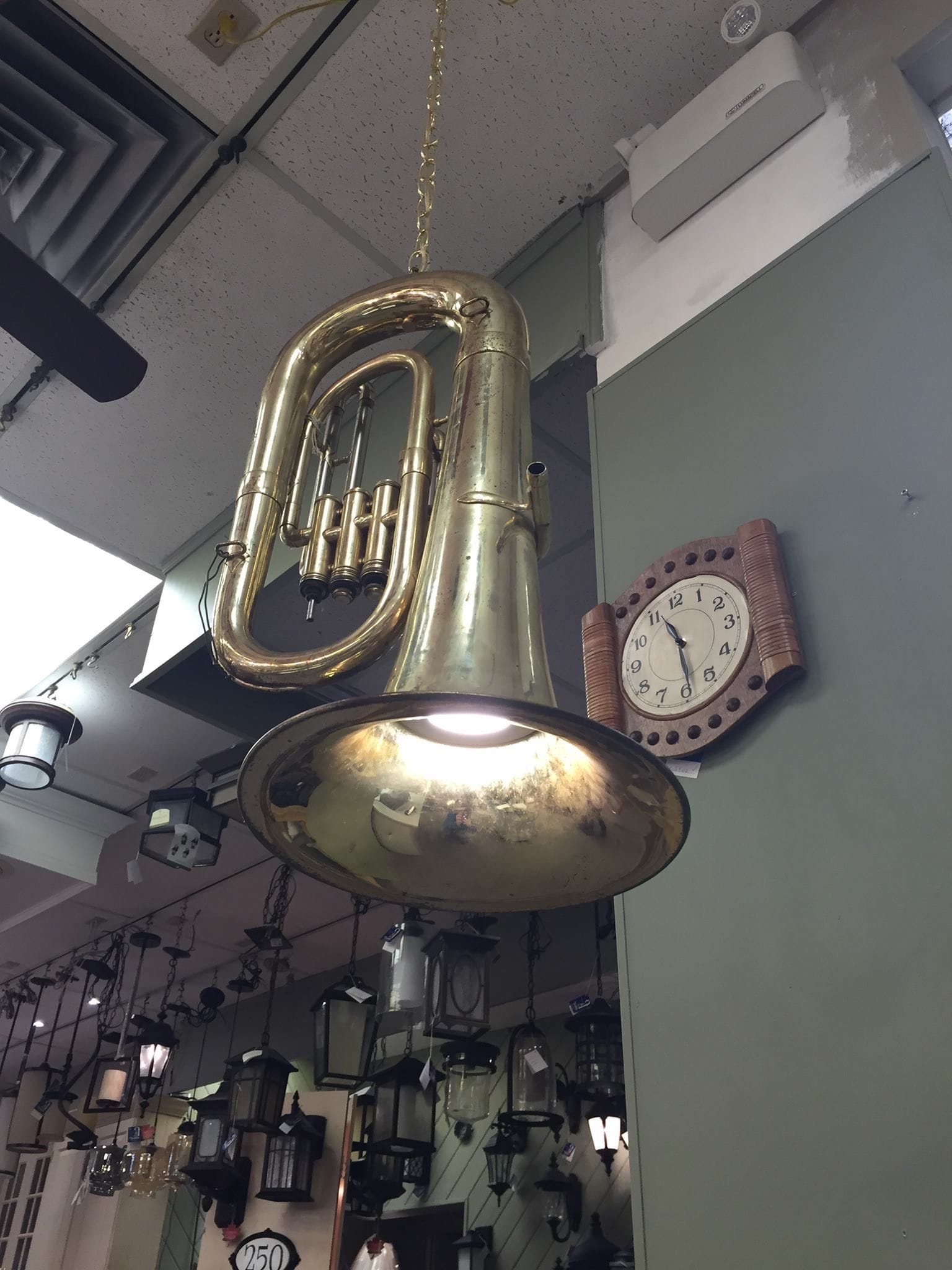 Hanging light made from a large brass instrument.