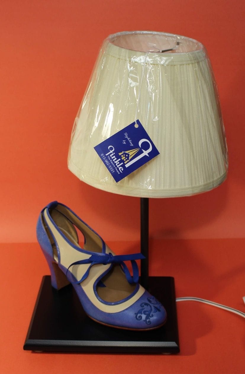 Small lamp with a blue high-heeled-shoe base and a pale shade.