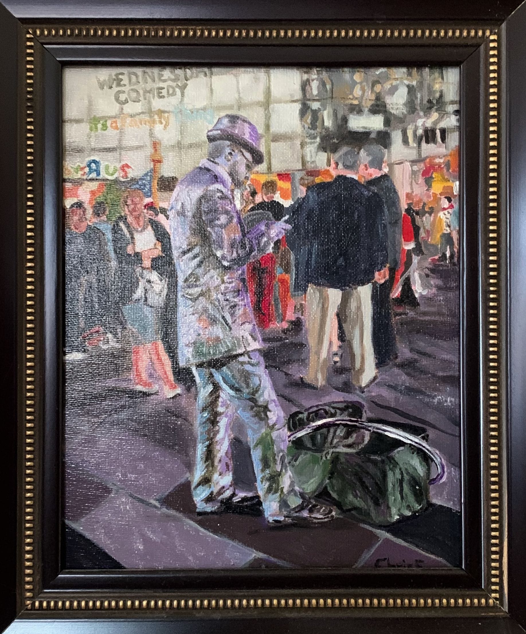 Framed painting of a silver-costumed street performer taking a smoking break in Times Square.