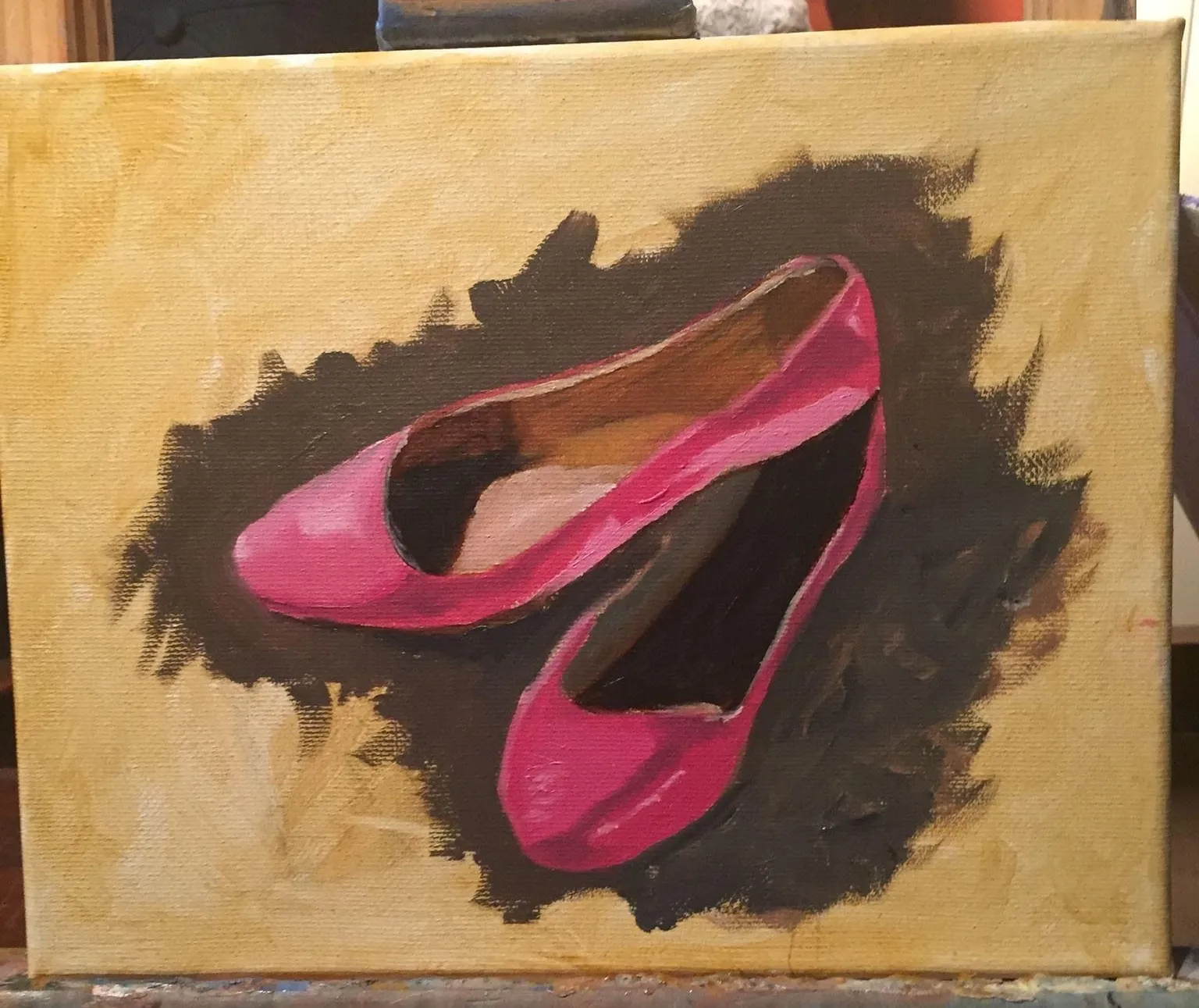 Practice painting of a pair of red shoes on an ochre surface.