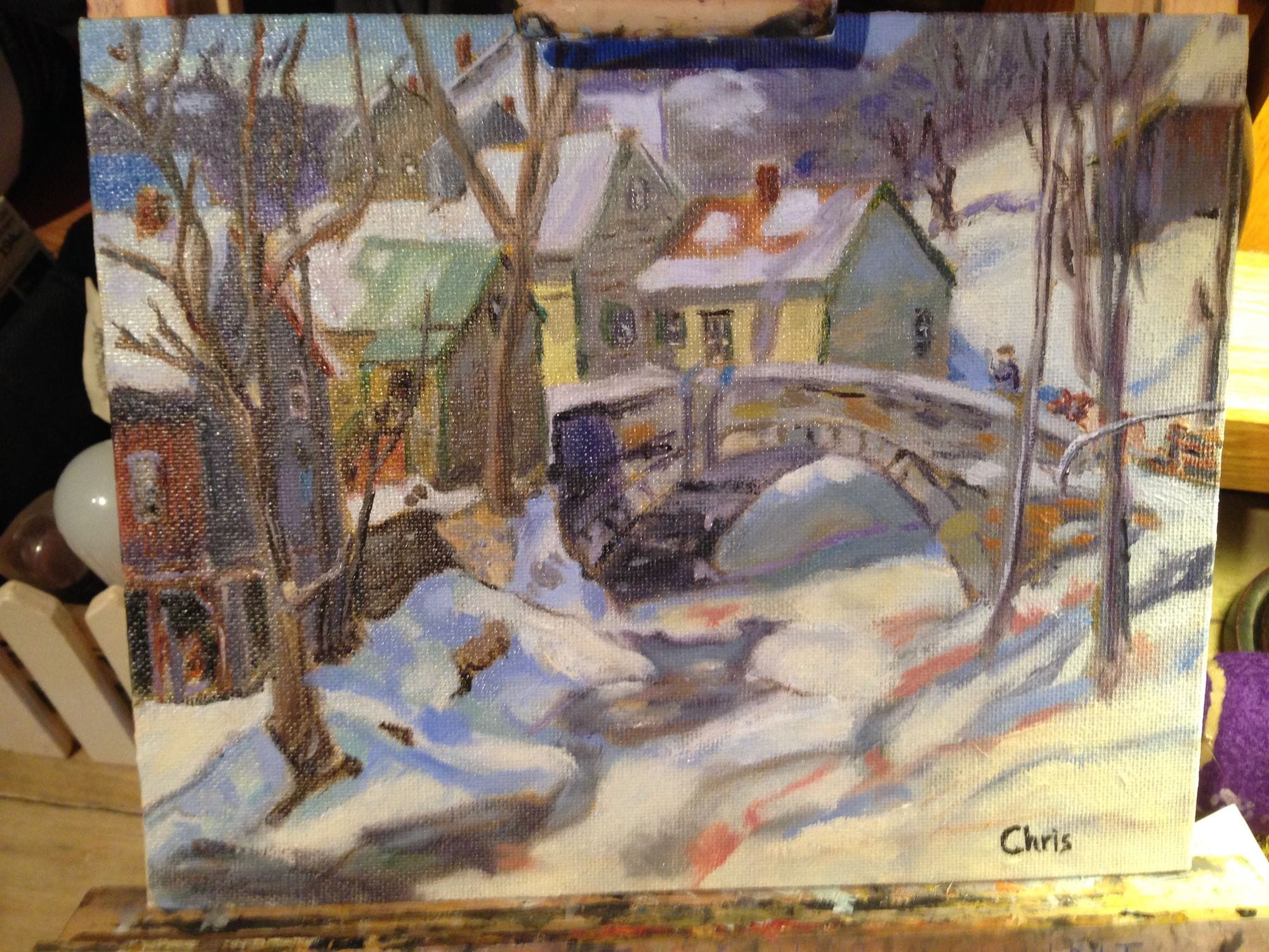 Painting study of a snow-covered village with a small bridge and bare trees.